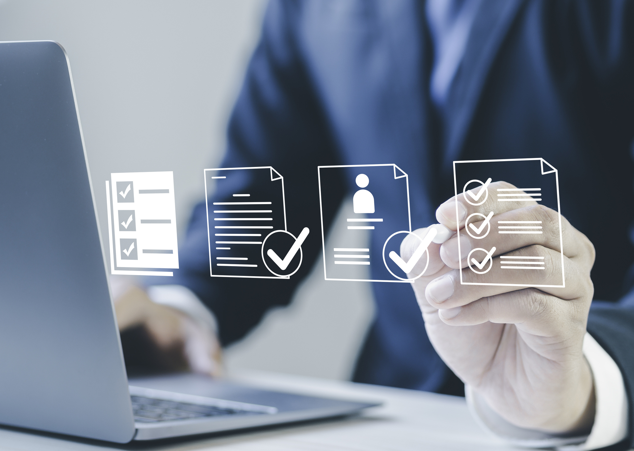 Business professional reviewing digital recruitment checklists and candidate profiles on a laptop, representing staffing services, employee screening, and workforce management.